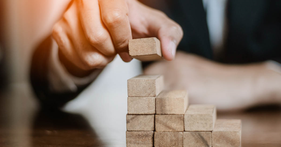 person stacking blocks representing channel partner recovery